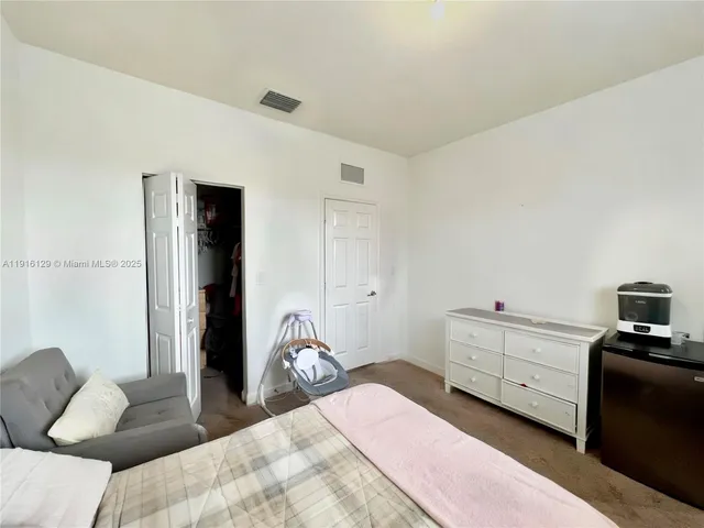 a bedroom with a bed and a tv