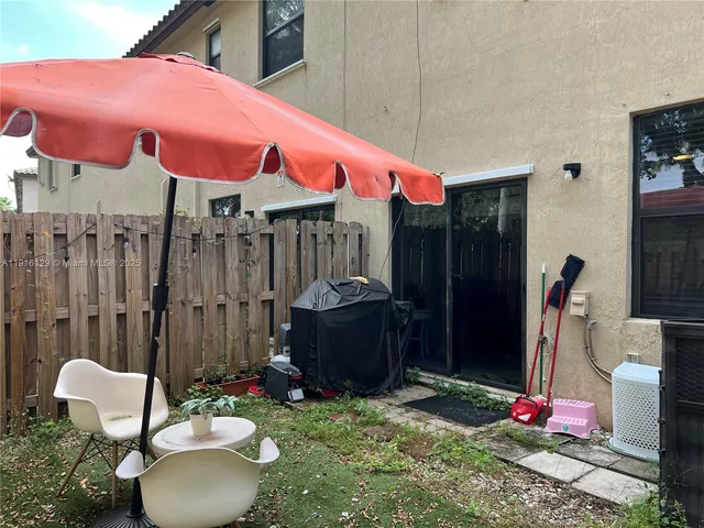 a backyard of a house with outdoor seating