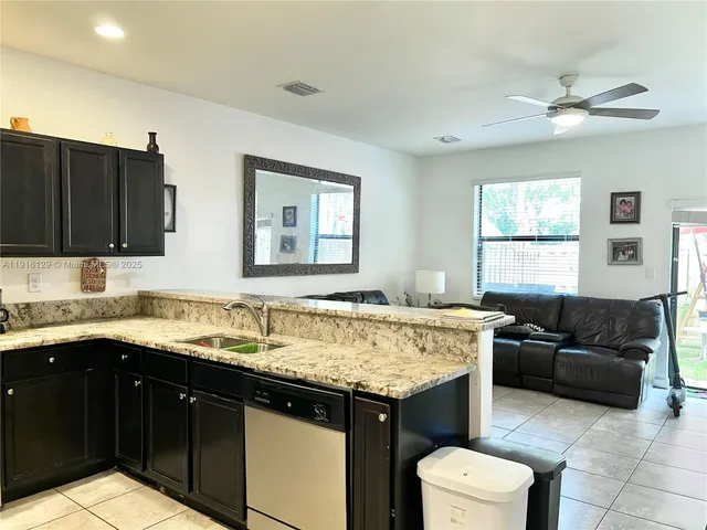 a kitchen with a stove a sink and a refrigerator