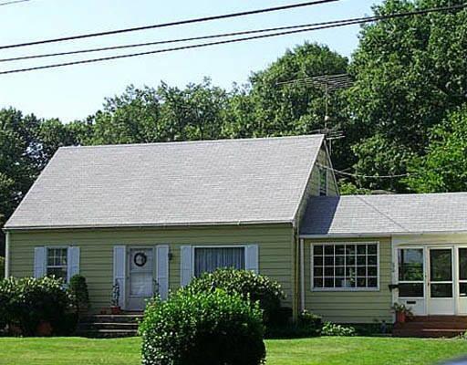 a house that has a tree in front of it