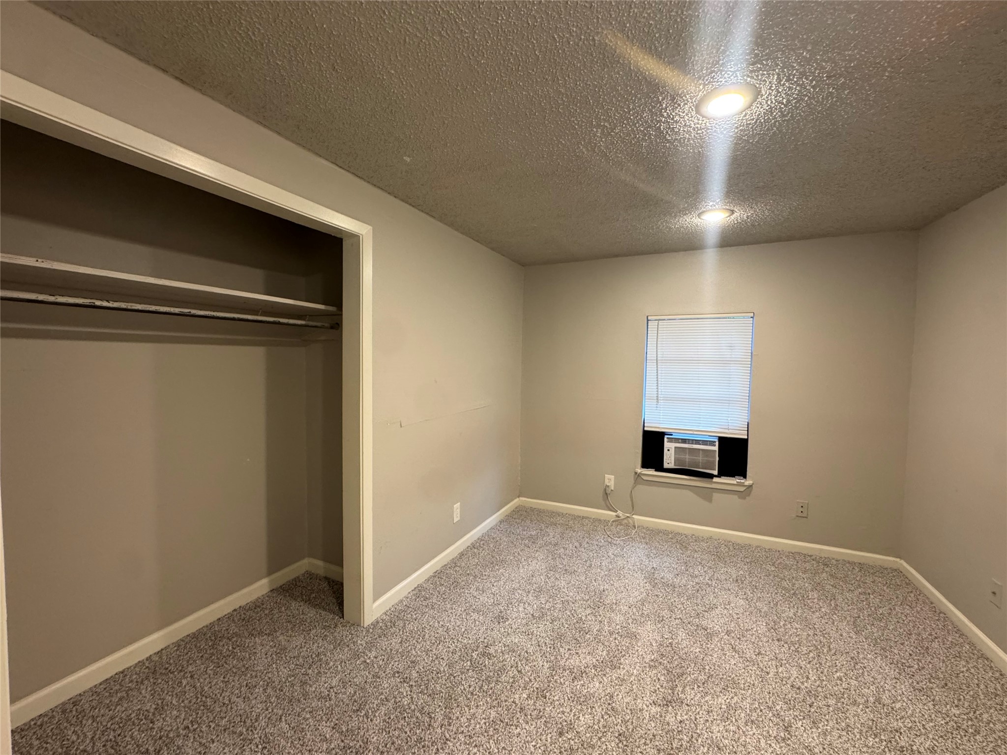 5007 Heflin Lane Austin, TX 78721 - Photo 16 of 25 A well-lit bedroom features plush carpeting and convenient closet space.