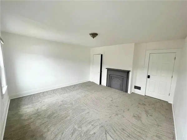 a view of empty room with a fireplace
