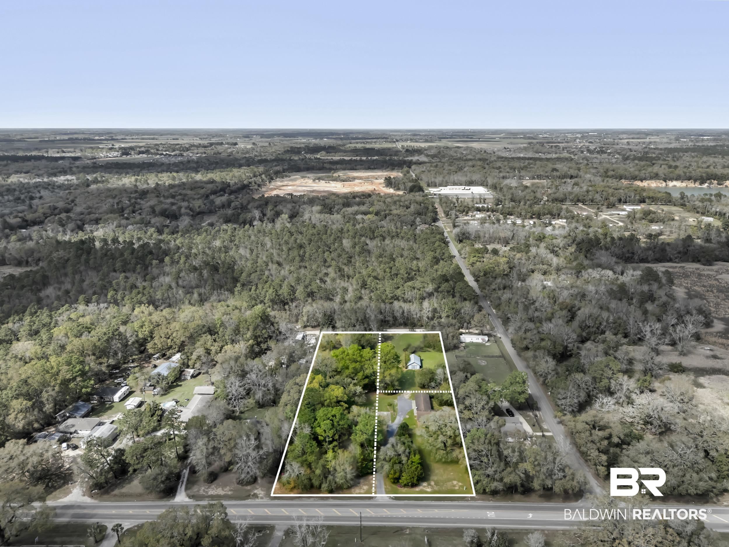 17463 Highway 98 Foley, AL 36535 - Photo 38 of 57 Aerial view of property and surrounding area featuring a heavily wooded area and property boundaries highlighted