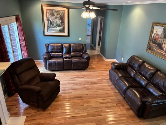 a living room with furniture and a mirror