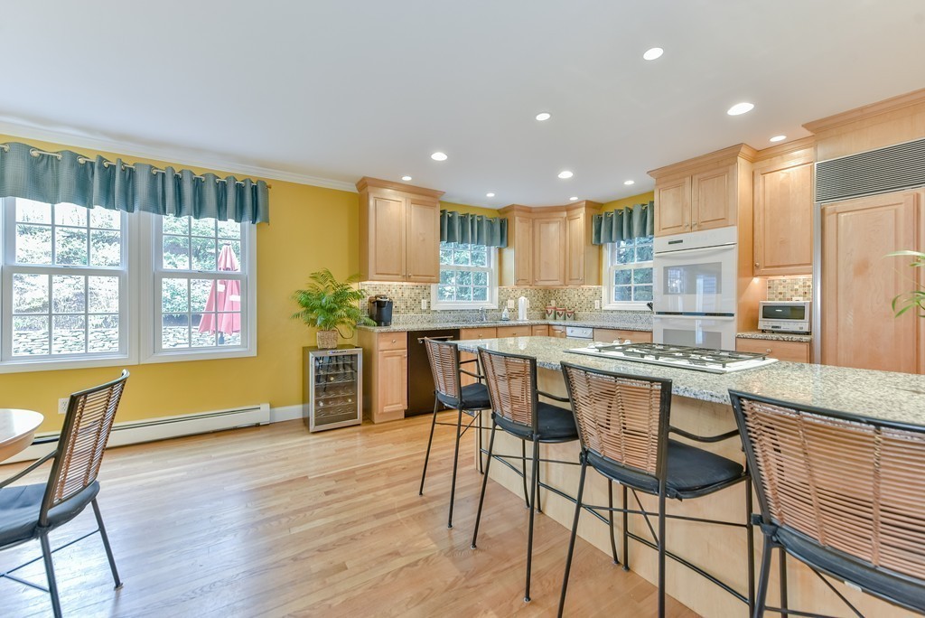 15 Whitney Road Newton, MA 02460 - Photo 11 of 23 a kitchen with stainless steel appliances granite countertop wooden floor window and cabinets