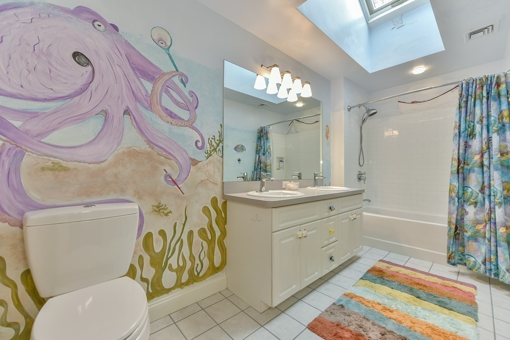15 Whitney Road Newton, MA 02460 - Photo 19 of 23 a spacious bathroom with a granite countertop toilet sink and mirror