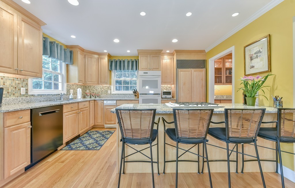 15 Whitney Road Newton, MA 02460 - Photo 10 of 23 a kitchen with stainless steel appliances granite countertop wooden floor dining table and chairs