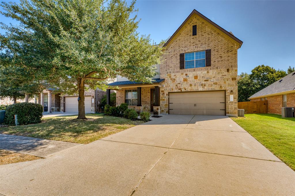11033 Desert Willow Loop Austin, TX 78748 - Photo 1 of 19 a front view of a house with a yard and garage