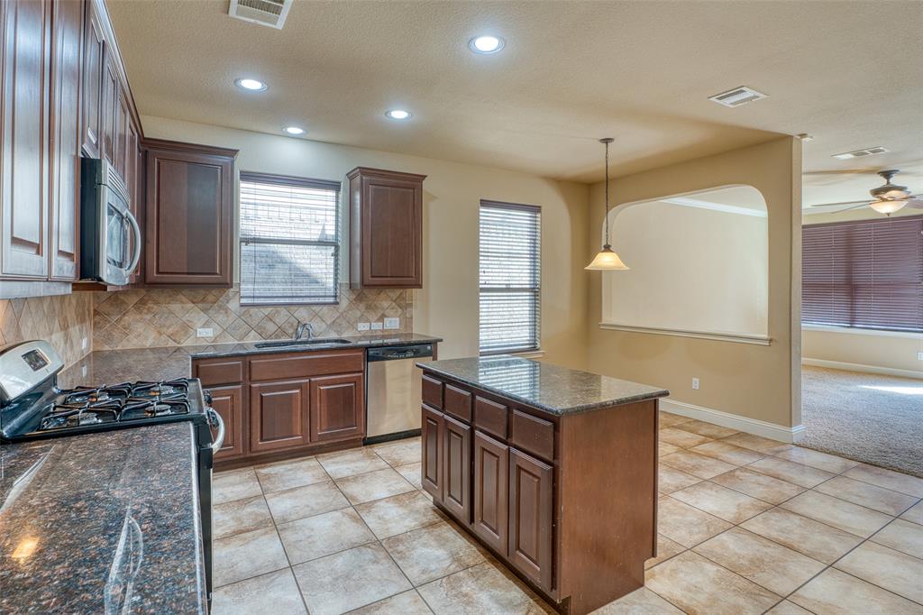 11033 Desert Willow Loop Austin, TX 78748 - Photo 4 of 19 a kitchen with stainless steel appliances granite countertop a sink counter space cabinets and a large window