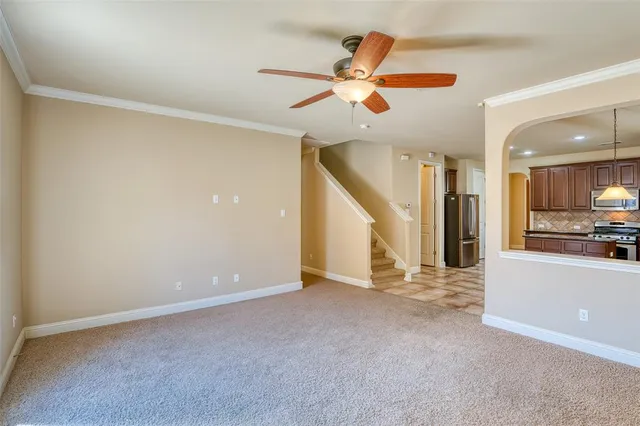 an empty room with fan and a ceiling fan