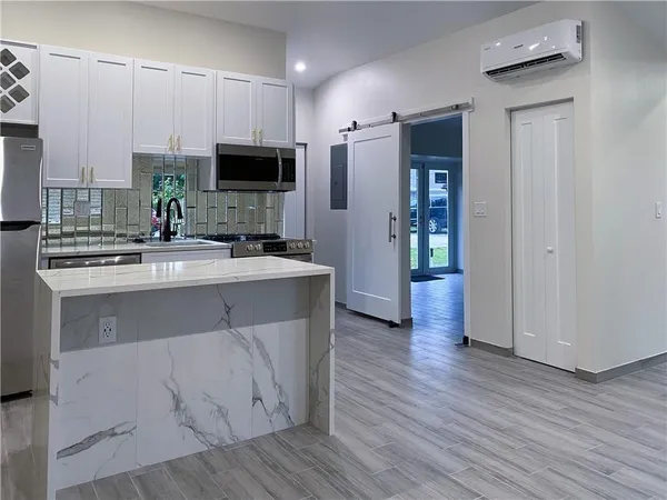 a kitchen with stainless steel appliances a sink stove and refrigerator