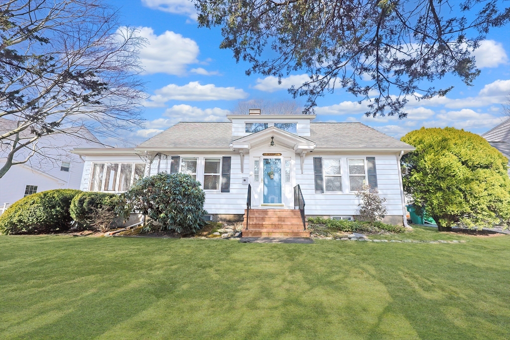 a front view of a house with garden