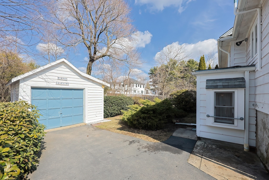 32 Sexton Avenue Westwood, MA 02090 - Photo 3 of 33 a front view of a house with a yard and garage