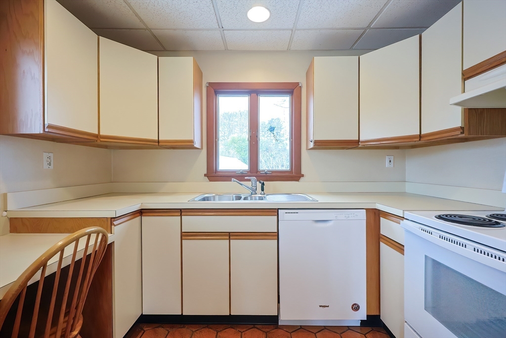 32 Sexton Avenue Westwood, MA 02090 - Photo 8 of 33 a kitchen with stainless steel appliances granite countertop a sink and cabinets with wooden floor