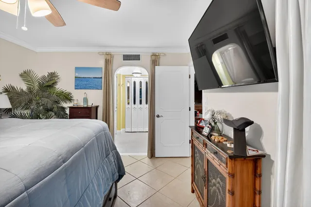 a bedroom with a bed and mirror