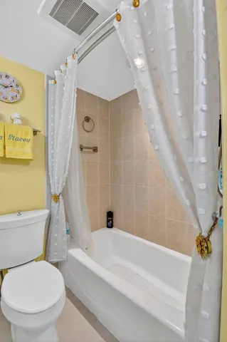 a bathroom with a toilet and a bathtub