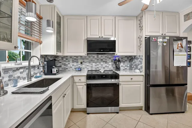 a kitchen with a sink stove and refrigerator