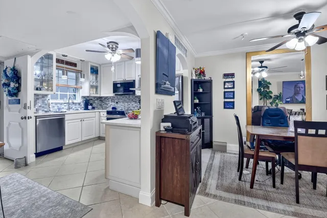 a kitchen with cabinets and chairs