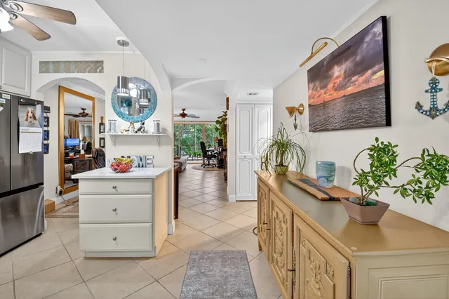 a hallway with cabinets and wooden floor
