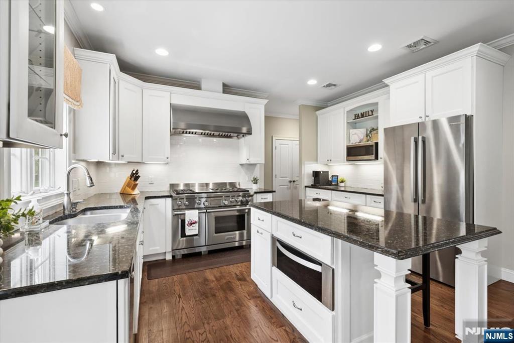 8 Forest Drive Mendham, NJ 07945 - Photo 14 of 43 a kitchen with stainless steel appliances granite countertop a stove and a refrigerator