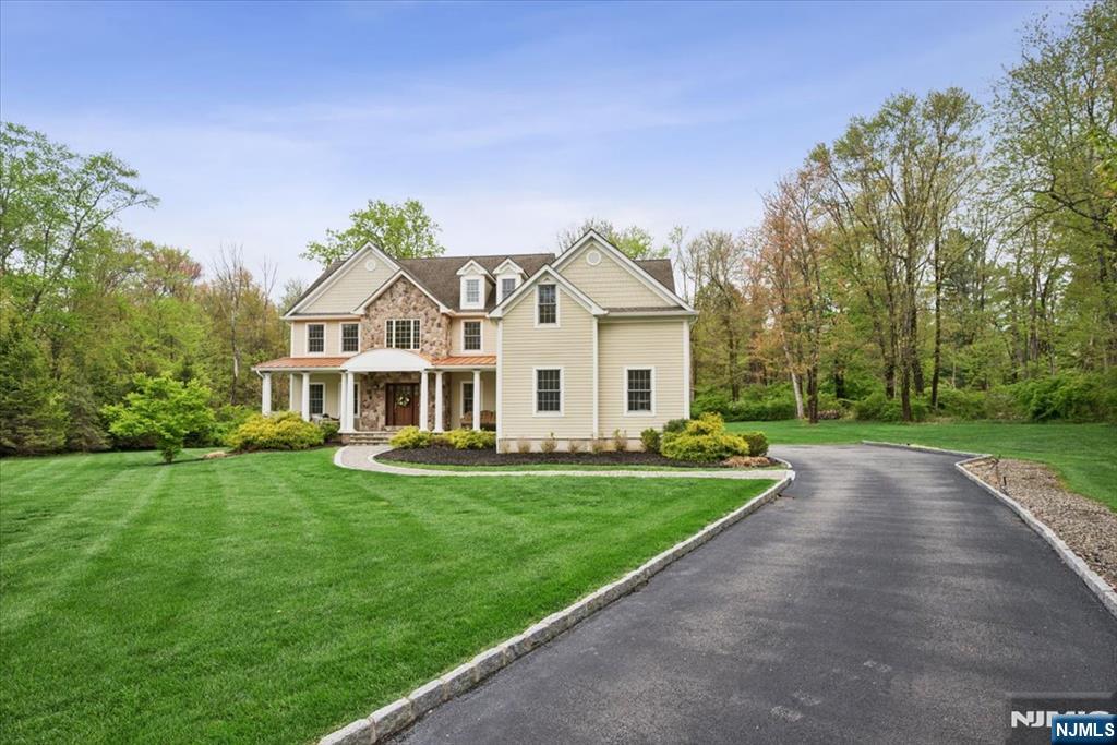 8 Forest Drive Mendham, NJ 07945 - Photo 2 of 43 a front view of a house with a yard table and chairs