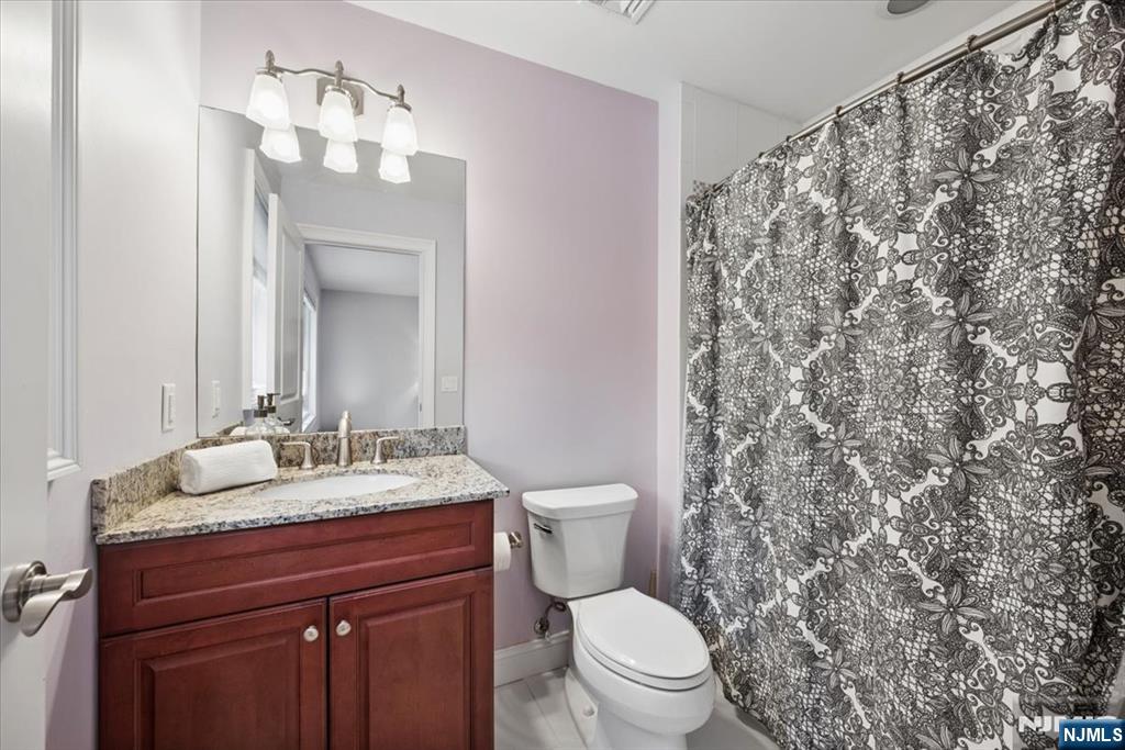 8 Forest Drive Mendham, NJ 07945 - Photo 27 of 43 a bathroom with a granite countertop sink toilet and mirror