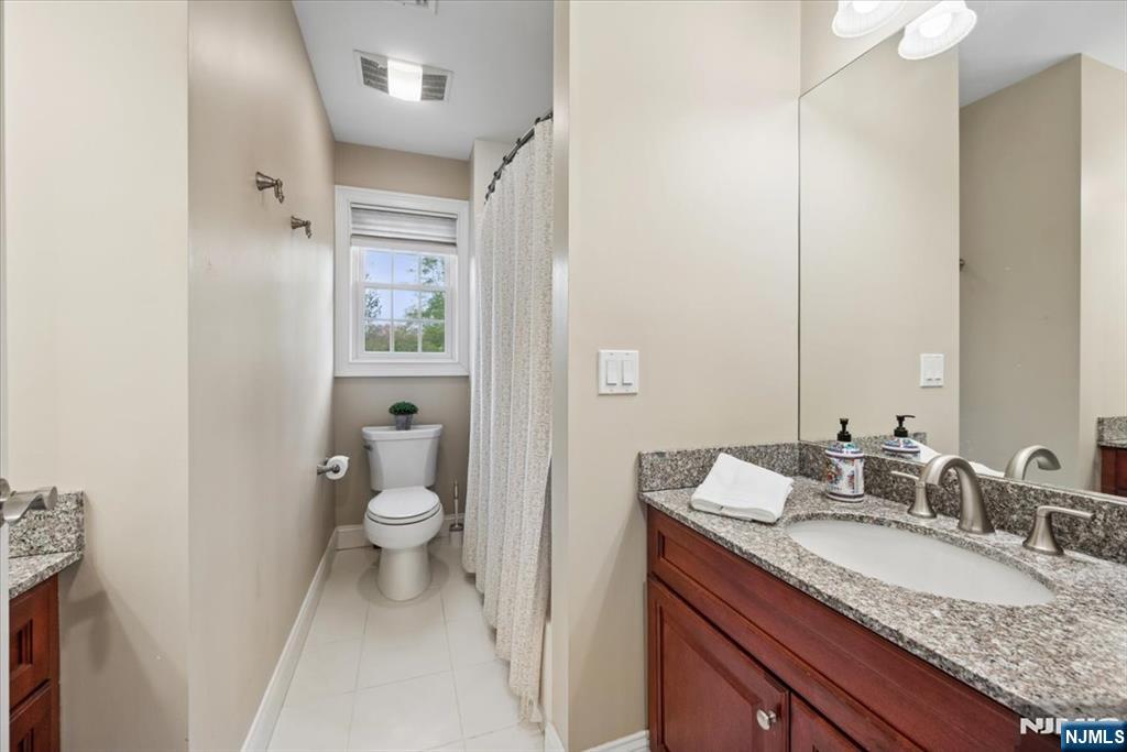 8 Forest Drive Mendham, NJ 07945 - Photo 29 of 43 a bathroom with a granite countertop sink toilet and shower