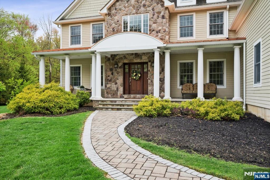 8 Forest Drive Mendham, NJ 07945 - Photo 3 of 43 a front view of a house with garden