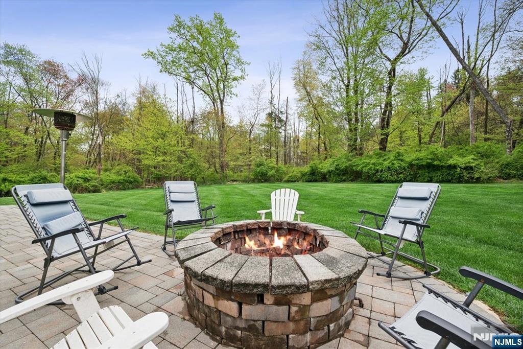 8 Forest Drive Mendham, NJ 07945 - Photo 36 of 43 a view of a patio with table and chairs potted plants and a palm tree