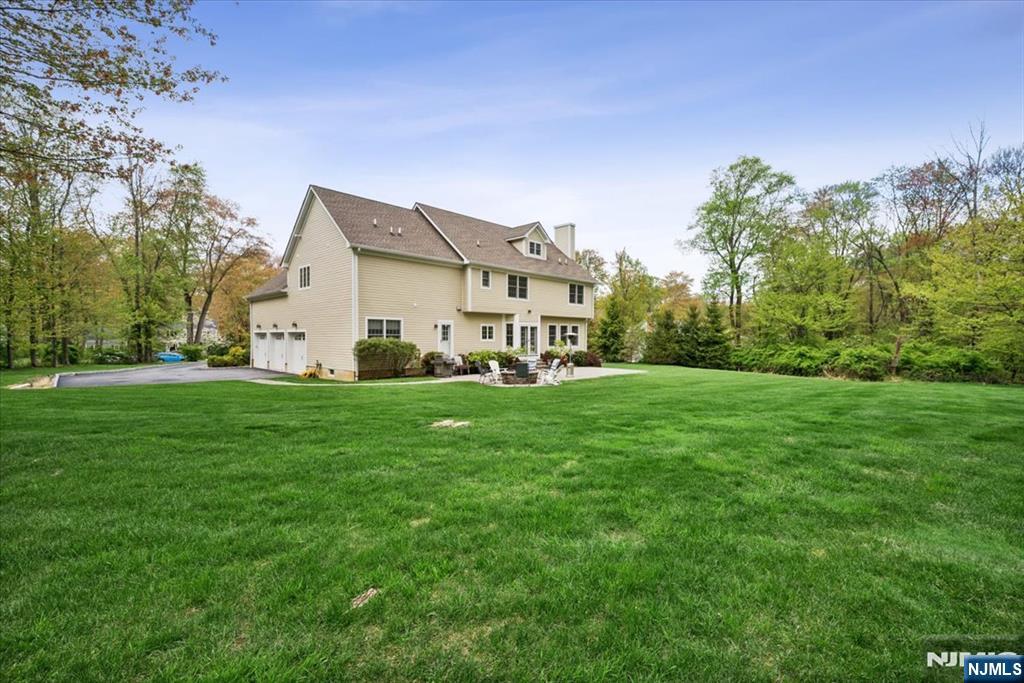 8 Forest Drive Mendham, NJ 07945 - Photo 38 of 43 a view of a white house with a big yard plants and large trees