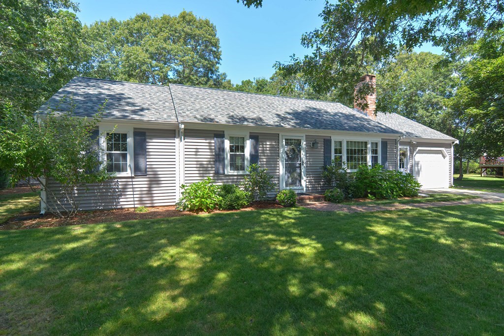 61 Tarpon Road Falmouth, MA 02536 - Photo 1 of 42 a view of a house with a yard potted plants and large tree