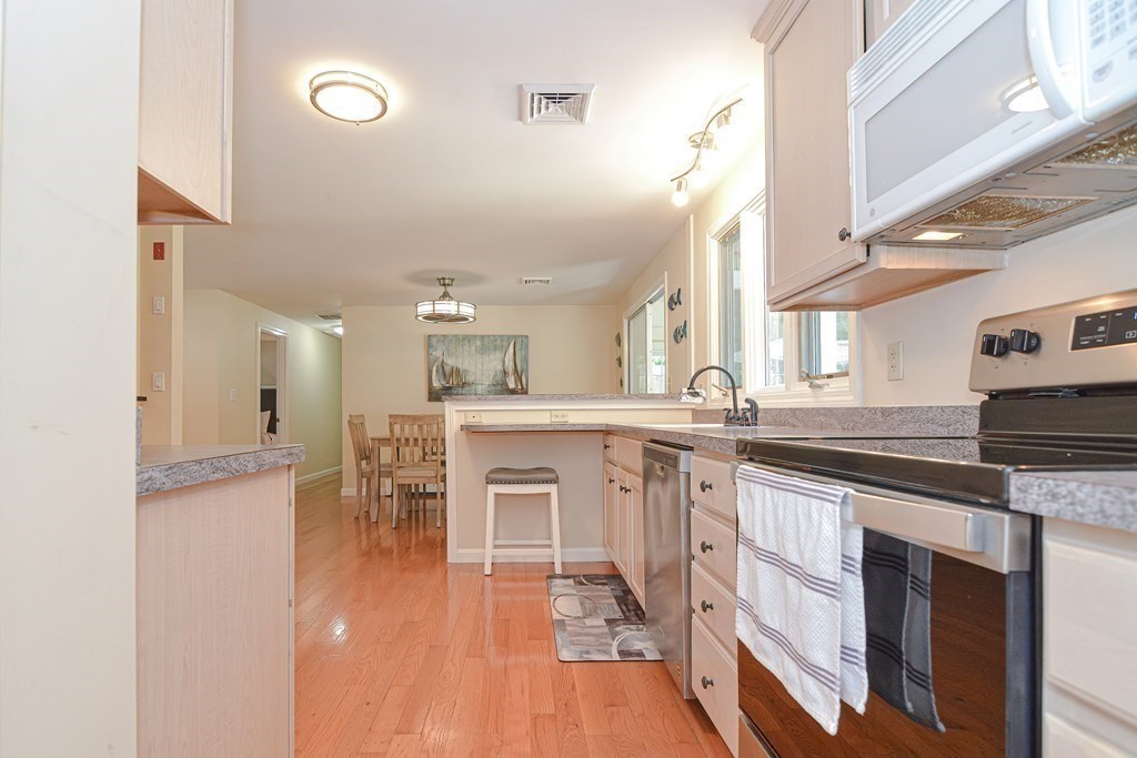 61 Tarpon Road Falmouth, MA 02536 - Photo 14 of 42 a kitchen with stainless steel appliances granite countertop a sink and cabinets