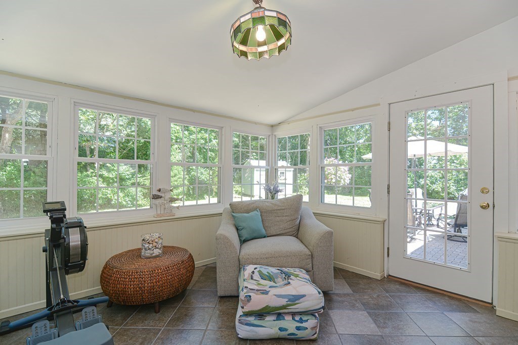 61 Tarpon Road Falmouth, MA 02536 - Photo 16 of 42 a living room with furniture and a floor to ceiling window