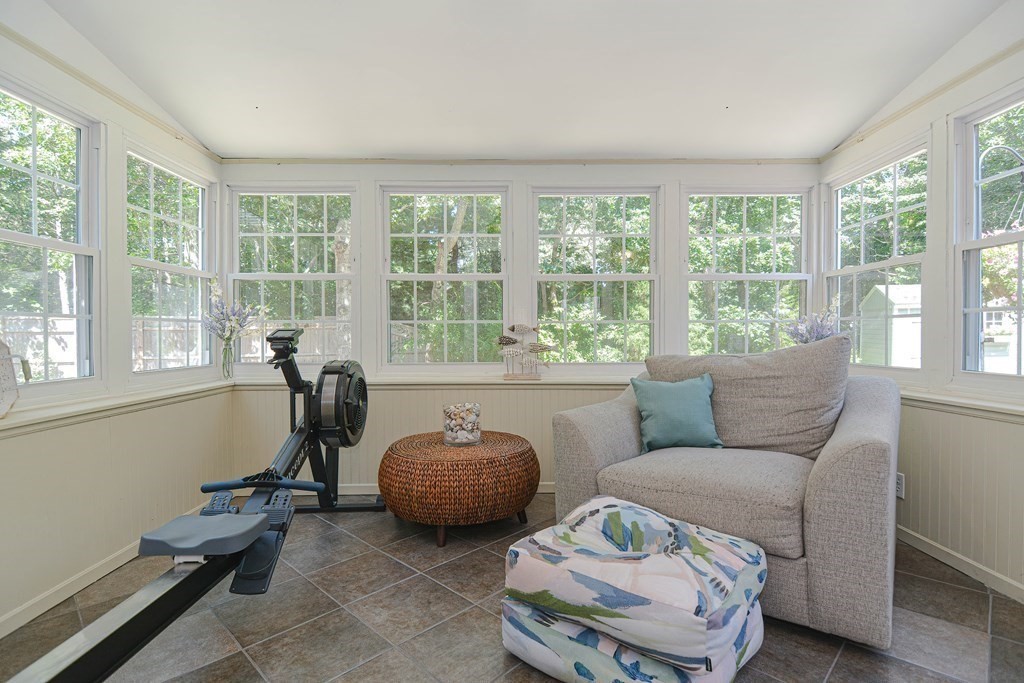 61 Tarpon Road Falmouth, MA 02536 - Photo 18 of 42 a living room with furniture and a floor to ceiling window
