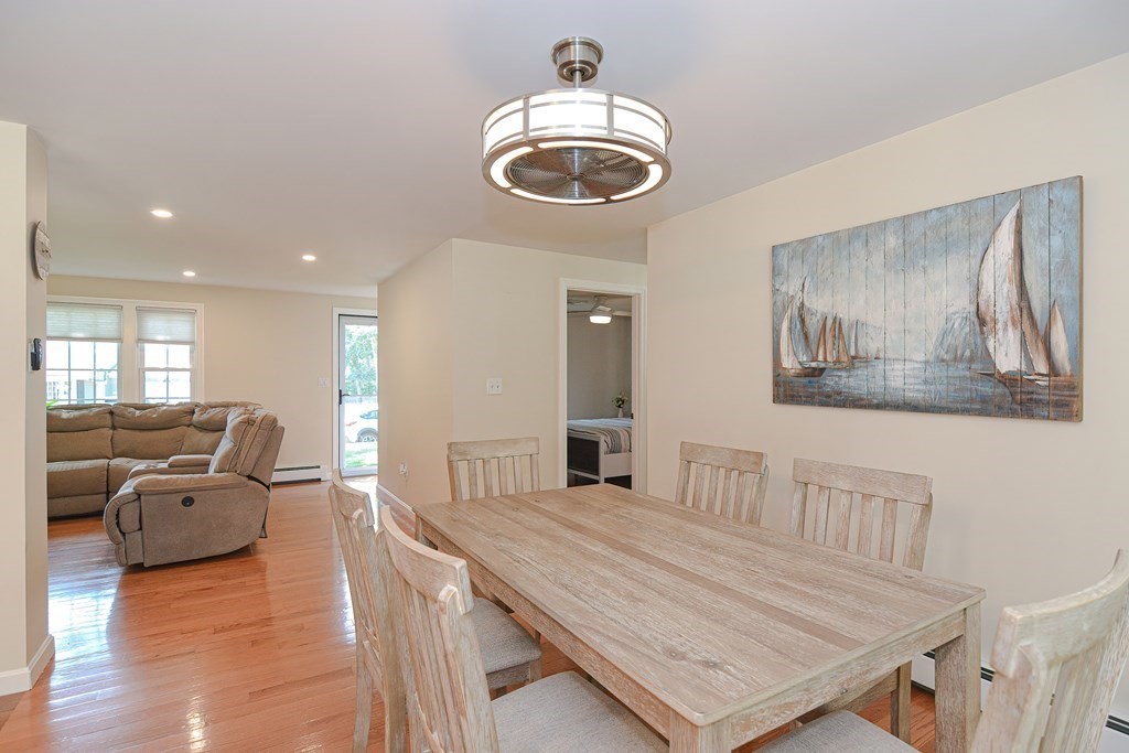 61 Tarpon Road Falmouth, MA 02536 - Photo 20 of 42 a living room with furniture and a chandelier