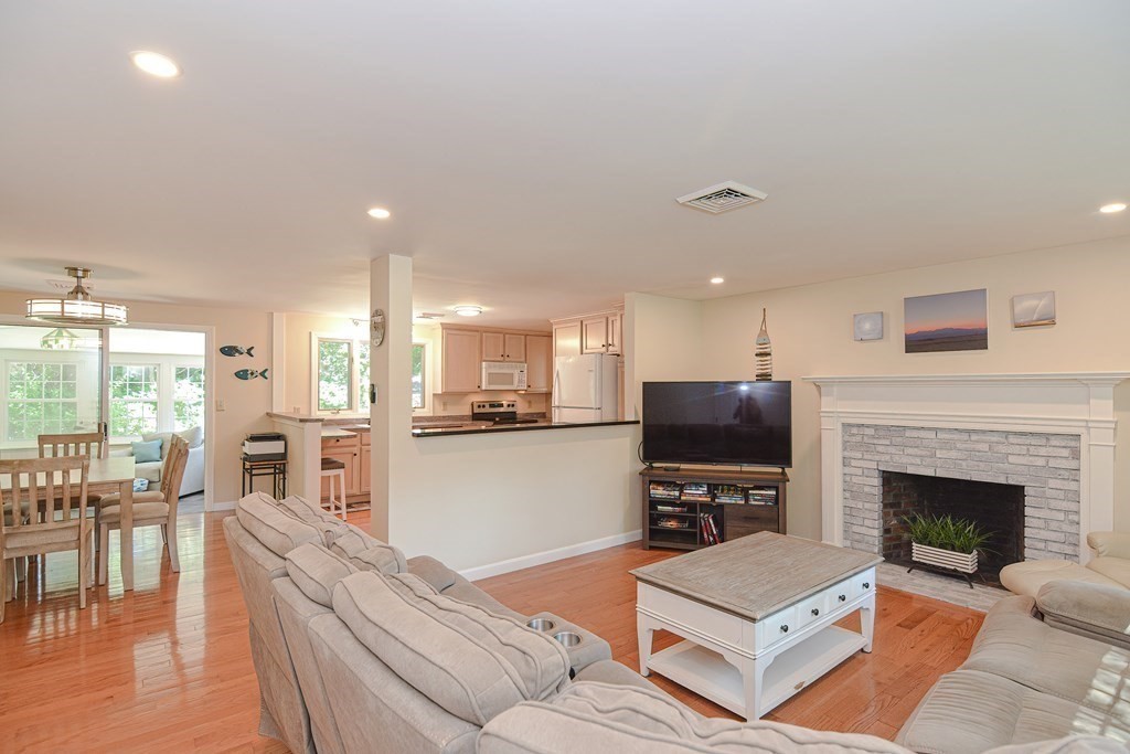 61 Tarpon Road Falmouth, MA 02536 - Photo 2 of 42 a living room with furniture flat screen tv and a fireplace