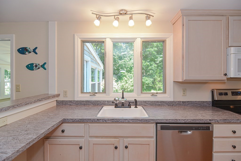 61 Tarpon Road Falmouth, MA 02536 - Photo 23 of 42 a kitchen with a granite countertop sink and window