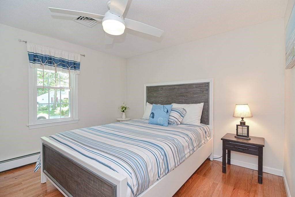 61 Tarpon Road Falmouth, MA 02536 - Photo 27 of 42 a bedroom with a bed and a lamp