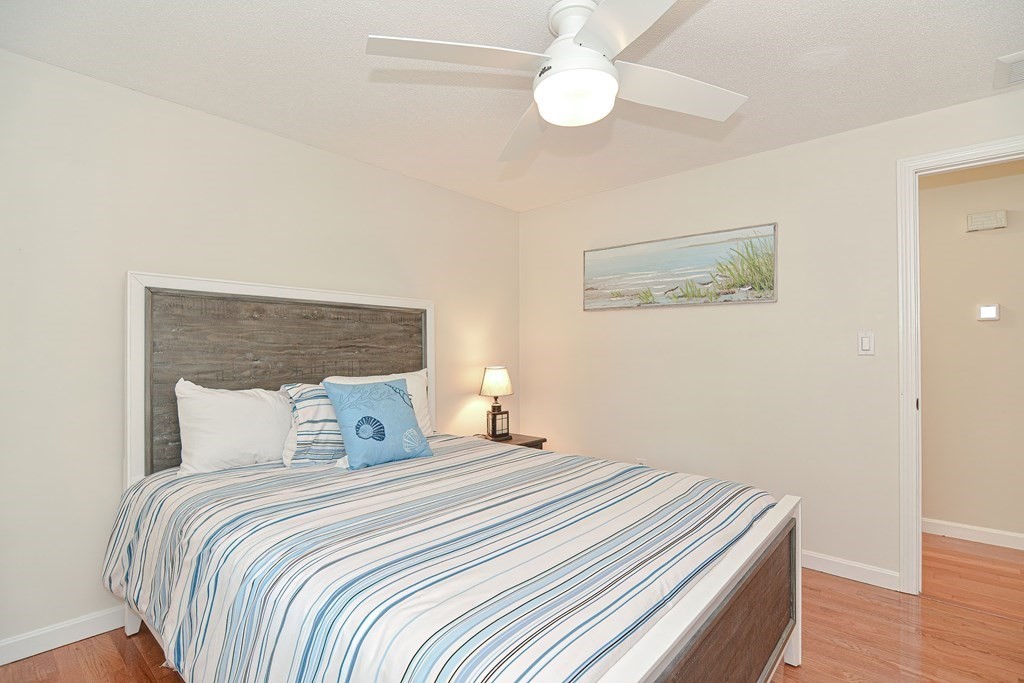 61 Tarpon Road Falmouth, MA 02536 - Photo 28 of 42 a bedroom with a bed and wooden floor