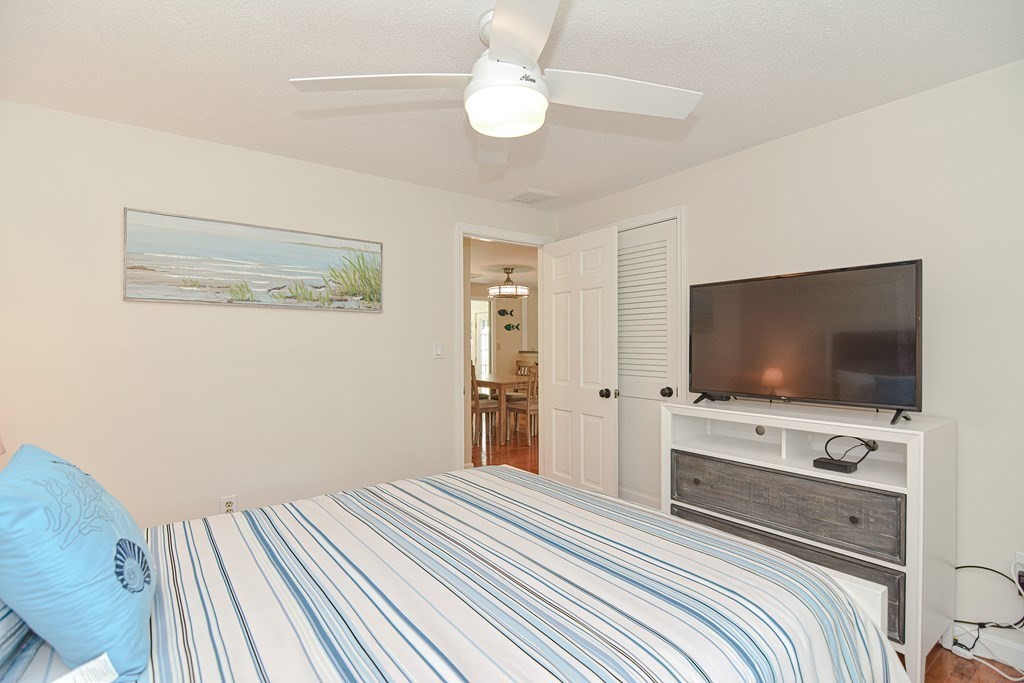 61 Tarpon Road Falmouth, MA 02536 - Photo 29 of 42 a bedroom with a bed and a flat screen tv