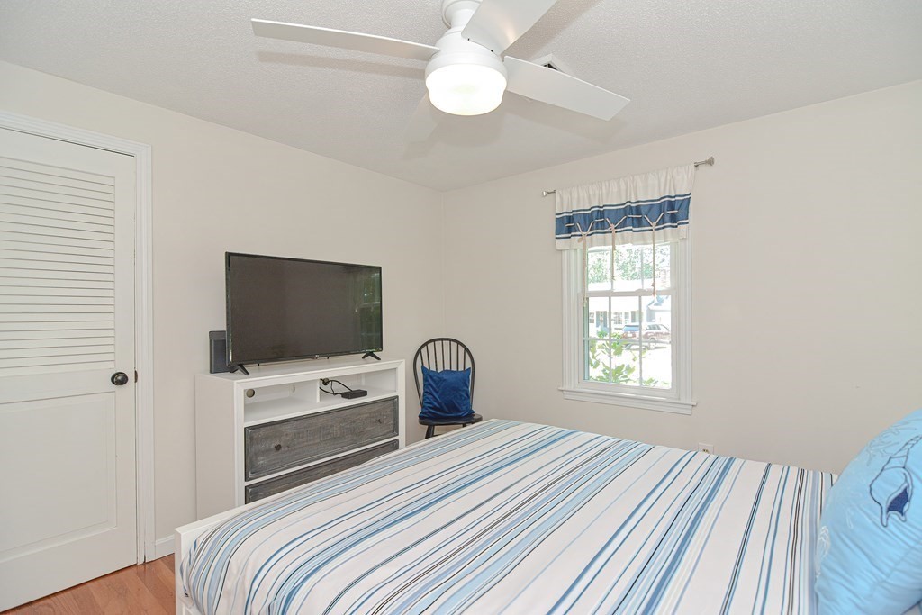61 Tarpon Road Falmouth, MA 02536 - Photo 30 of 42 a bedroom with a bed and a flat screen tv