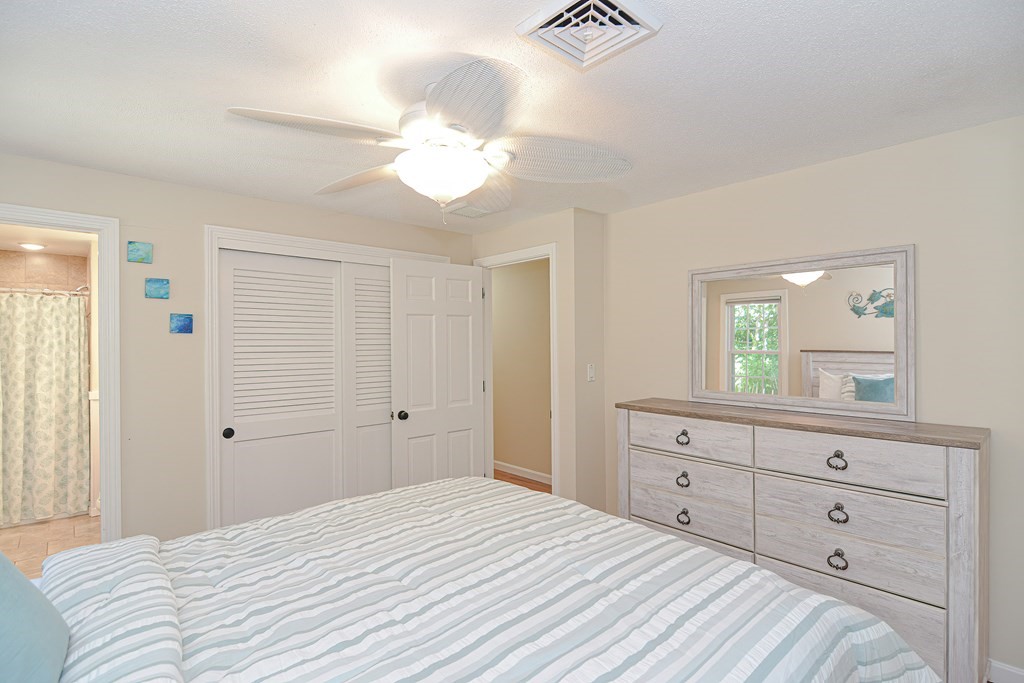 61 Tarpon Road Falmouth, MA 02536 - Photo 33 of 42 a bedroom with a bed and a mirror on dresser
