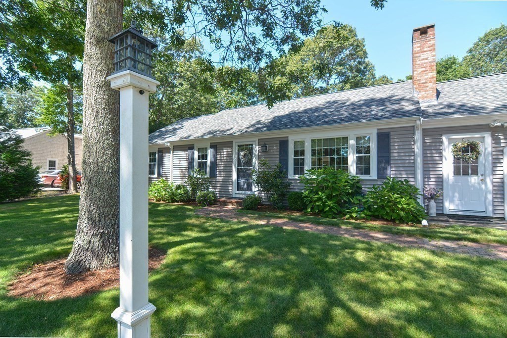 61 Tarpon Road Falmouth, MA 02536 - Photo 5 of 42 a view of a house with a yard and plants