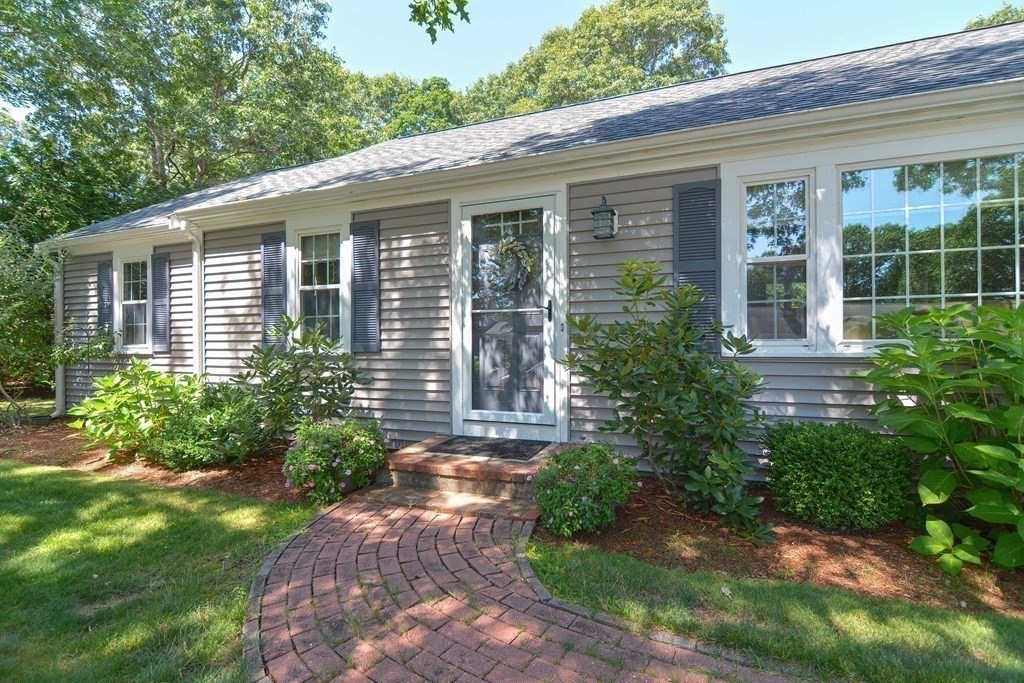 61 Tarpon Road Falmouth, MA 02536 - Photo 6 of 42 a front view of a house with garden