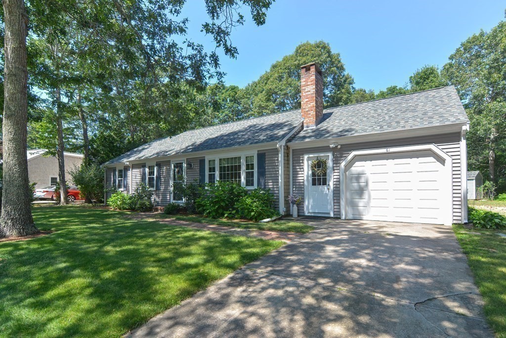 61 Tarpon Road Falmouth, MA 02536 - Photo 7 of 42 a front view of a house with a yard and garage