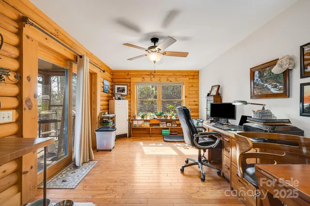 a view of a livingroom with workspace and a window