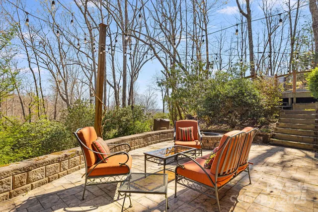 a view of a chairs and table in the backyard