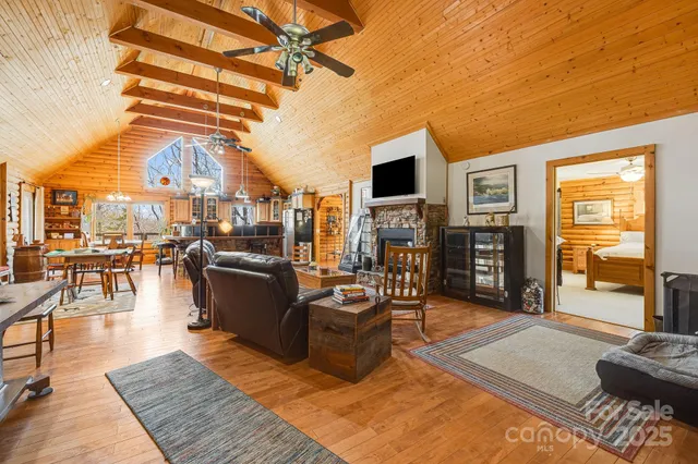 a living room with furniture a rug and a flat screen tv