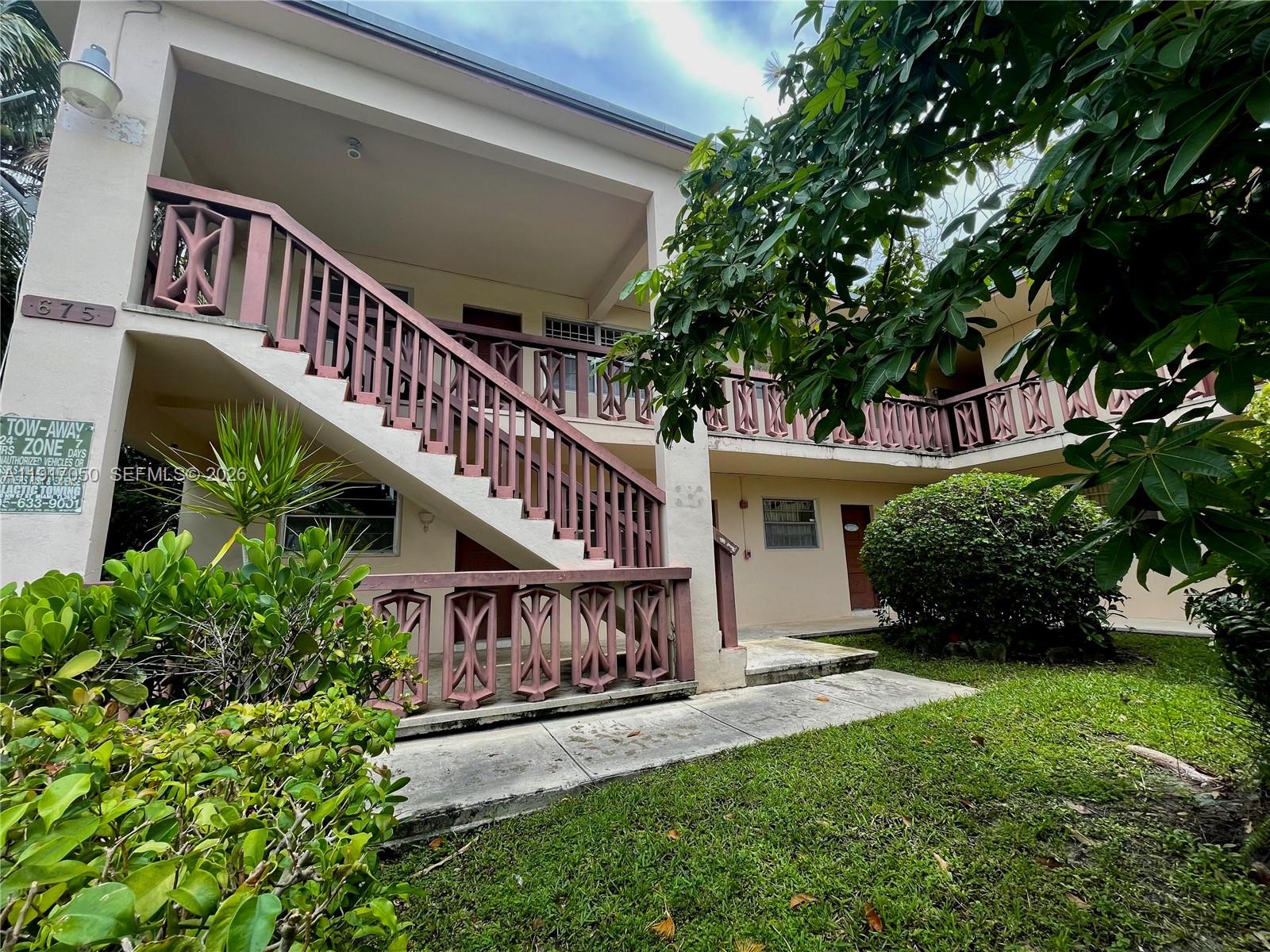 675 Southwest 7th Avenue, Unit 12 Miami, FL 33130 - Photo 12 of 13 a view of a house with brick walls and a yard with plants