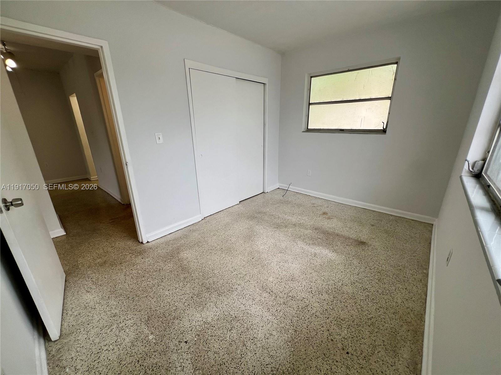 675 Southwest 7th Avenue, Unit 12 Miami, FL 33130 - Photo 8 of 13 an empty room with a mirror